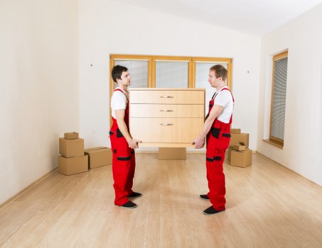 Professional removal team loading furniture during a local move