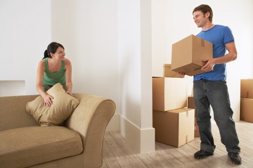 Apartment moving team handling furniture in Forestgate